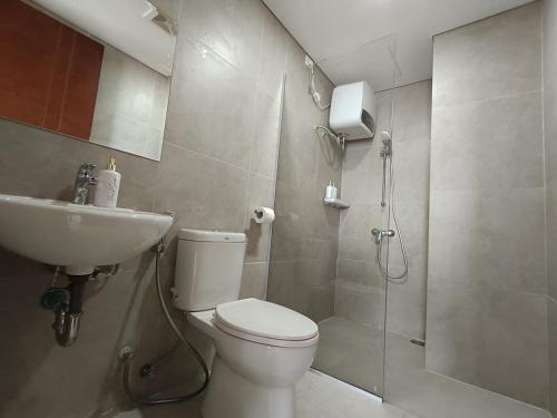 a bathroom with a shower and a toilet and a sink at 2BR Pollux Habibie Meisterstadt Tower 1 Batam City in Batam Center