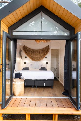 a bedroom with a bed and a large window at Parco Ibiza, by Camping San Antonio est 1961 in San Antonio