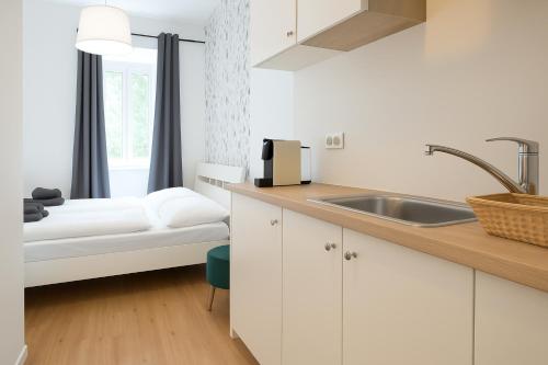Cama o camas de una habitación en DAINN Apartments Schönbrunn