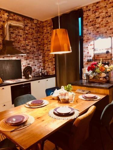 a wooden table in a kitchen with a dining room at Slapen bij de Brug in Zuidveld