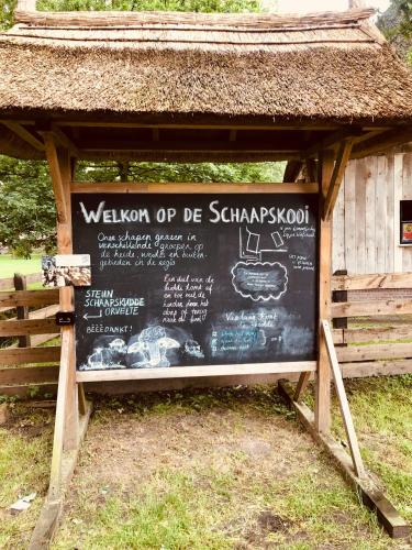 a sign in a building with a menu on it at Slapen bij de Brug in Zuidveld