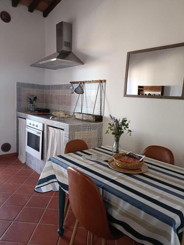 a kitchen with a table with a blue and white table cloth at Agriturismo Fattoria Alessandrini in Principina Terra