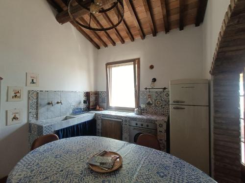 a kitchen with a table with a hat on it at Agriturismo Fattoria Alessandrini in Principina Terra