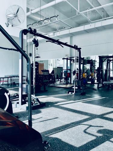 a gym with several machines in a large room at M Panda Tower Boutique Chengdu in Chengdu