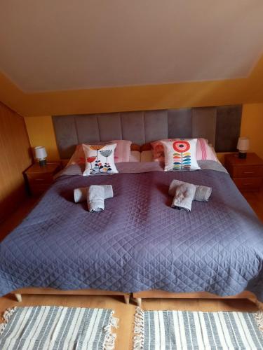 a bedroom with a large bed with two pillows at Stary Drahim in Czaplinek