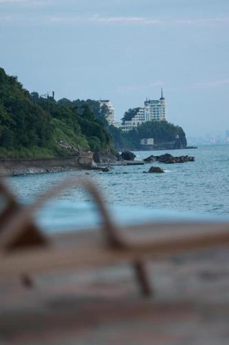 a view of the ocean from a beach with a building at Bamboo Beach Tsikhisdziri LATTE in Tsikhisdziri