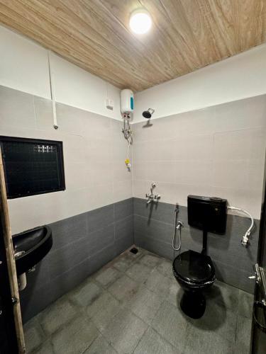 a bathroom with a toilet and a sink at Paradise A Social Hostel in Anjuna