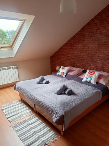 a bedroom with a bed and a brick wall at Stary Drahim in Czaplinek