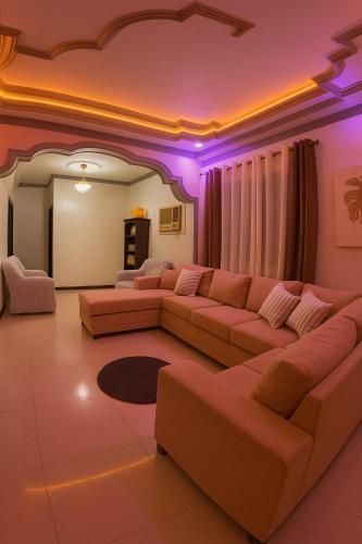 a living room with a couch and pink lighting at Spacious 3BR Home Comfy Beds Great Location 