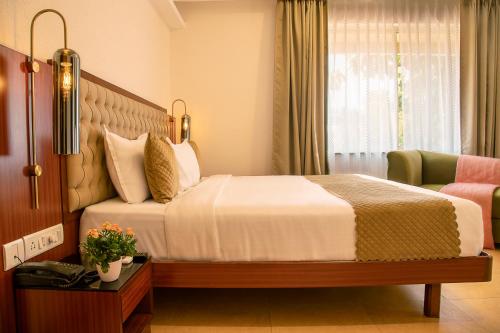 a hotel room with a bed and a window at TreeHouse Stamp in Colva