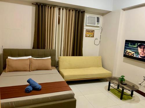 a living room with a bed and a couch at A&G Condotel at 101newport Near NAIA T3 in Manila