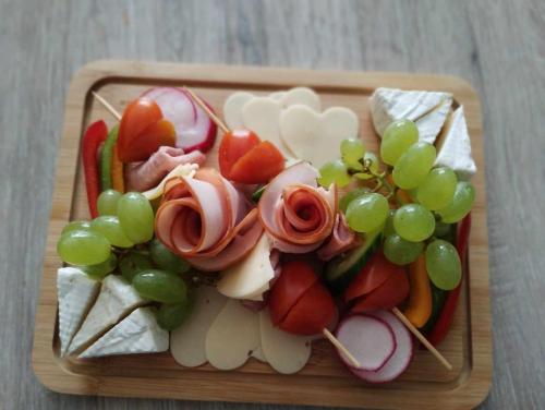 ein Teller mit Essen mit Gemüse und Trauben in der Unterkunft Apartment romantyczny SAKURA in Jędrzejów