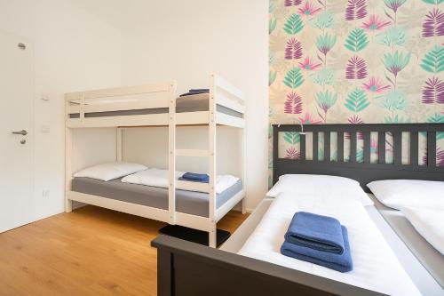 Cama o camas de una habitación en DAINN Apartments Schönbrunn