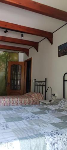 a bedroom with two beds and a window at Mizoun Paola Via Roma 9 in Aisone