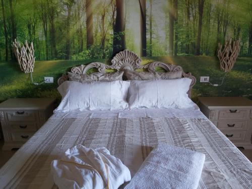 a bedroom with a bed with a painting on the wall at Cascina Olmetto di Sotto in Ghedi