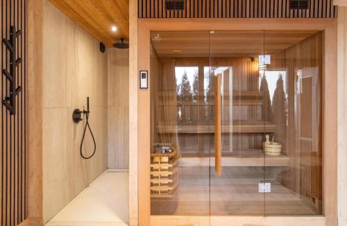a glass door leading into a room with wine bottles at Chalet Le Rokh in Landry