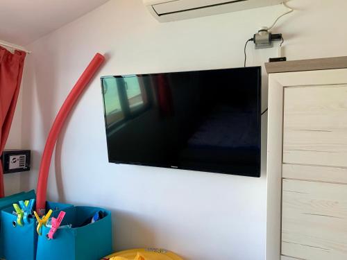 a flat screen tv hanging on a wall at Seaview Holiday - Черноморска почивка in Aheloy
