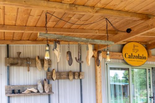 a room with a wall with various items hanging from the ceiling at Palagina Il Borgo Agricolo in Figline Valdarno