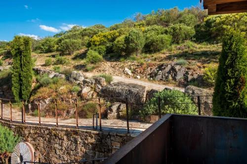 a staircase leading up to a hill with trees at Hotel Gredos María Justina in Navacepeda de Tormes