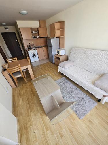 a living room with a white couch and a table at Julia Vigo Panorama apartments in Nesebar