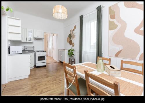 a kitchen and dining room with a table and chairs at RASL Residens,apartmán Art deco in Jihlava