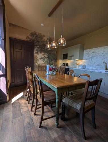 a dining room with a wooden table and chairs at Wonderland Berwick 5-bedrooms Pet-friendly cottage with the Hot tub in Tweedmouth