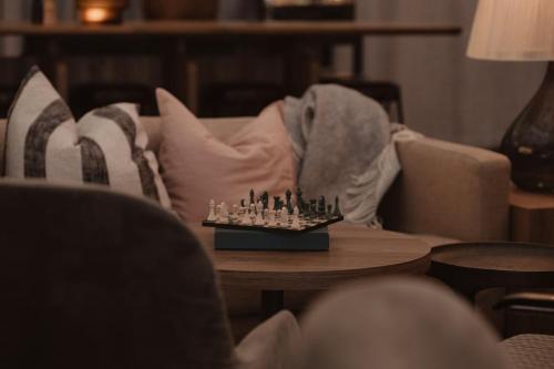 a chess board on a coffee table in a living room at Home Hotel Odin in Gothenburg