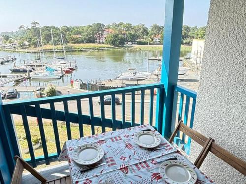 - une table sur un balcon avec vue sur le port de plaisance dans l'établissement Appartement avec terrasse, parking et vue sur port à Capbreton - FR-1-413-130, à Capbreton