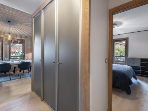 une chambre avec portes coulissantes menant à une salle à manger dans l'établissement Charmant Appartement à Rochebrune, Megève - Résidence avec Piscine, Sauna, Hammam et Salle de Sport - FR-1-569-30, à Megève