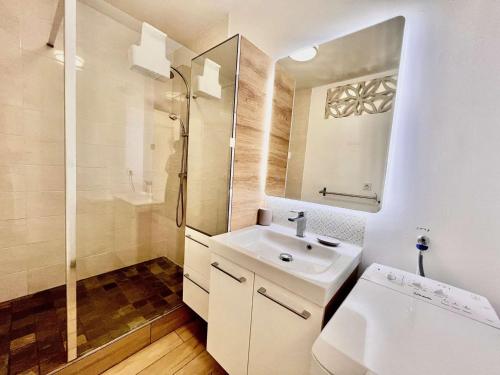 une salle de bain blanche avec un lavabo et une douche dans l'établissement Studio charmant avec terrasse ensoleillée et parking à Quiberon - FR-1-478-314, à Quiberon