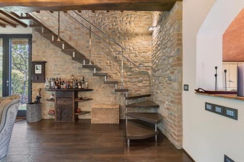 a staircase in a room with a brick wall at Tenuta Virgilio Colline del Chianti in Tavarnelle in Val di Pesa