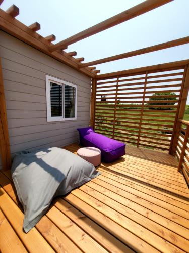 a bedroom with a bed on a wooden deck at VioVillas Agriturismo Glamping Arezzo in Arezzo