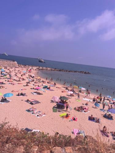 a large crowd of people on a beach at Logement insolite French Riviera avec parking in Antibes