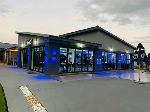 a building with blue lights in front of it at Apex Boutique Hotel in Estcourt