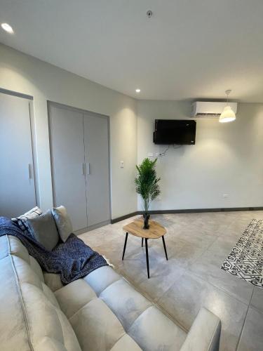 a living room with a couch and a table at AmazINN Places Casa Fortaleza in Panama City