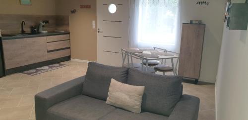 a living room with a couch and a table at Havre de paix en Bourgogne in Saint-Germain-du-Plain