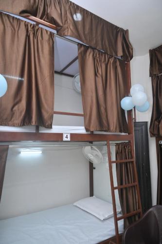 a bunk bed with a ladder and a window at Sankalp Yatri Nivas AC dormitory in Gwalior