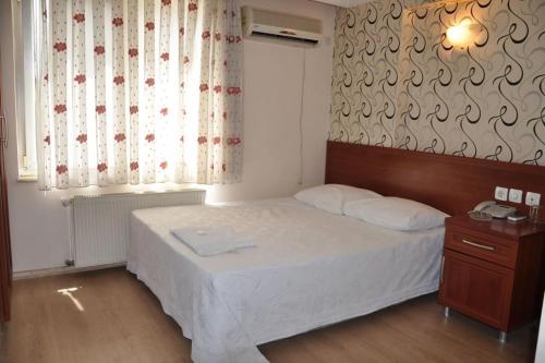 a small bedroom with a bed and a window at Şahin Otel1 in Samsun