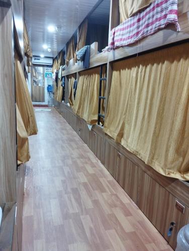 an empty aisle of an rv with curtains at Sun Shine AC Dormitory in Mumbai