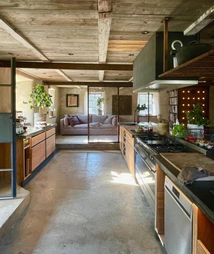 a large kitchen with a couch in the background at Månpalatset in Lärbro