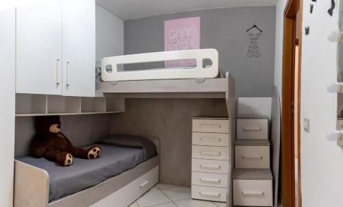 a toy bed with a teddy bear in a bunk room at Amalfi Coast Holiday Home in Salerno Airport - Aeroporto di Salerno