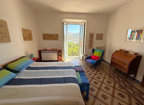 a bedroom with two beds and a desk and a window at Panoramic Apartments in Villa in Center "The Beach and The Cliff" 1 in Agropoli
