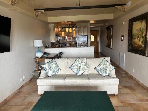 a living room with a couch with pillows on it at Ocean Lodge Resort in Demere Park