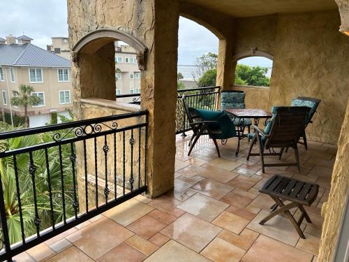 a balcony with chairs and a table on a balcony at Ocean Lodge Resort in Demere Park