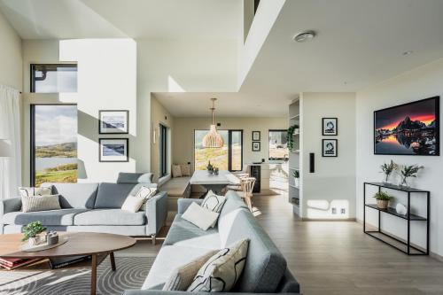 a living room with a couch and a table at Lofotendreams - Superior Chalet in Leknes