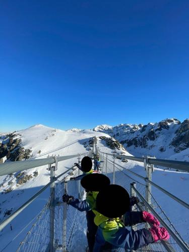 a group of people on a ski lift in the snow at Très bel appartement exposition sud classé 3 étoiles in Chamrousse