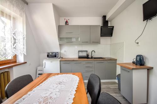 a kitchen with a table and chairs in a room at U Lańdy in Poronin
