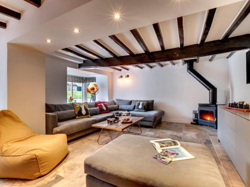 a living room with a couch and a fireplace at The Nook by Luxury Travel Emporium Asygarth in Aysgarth