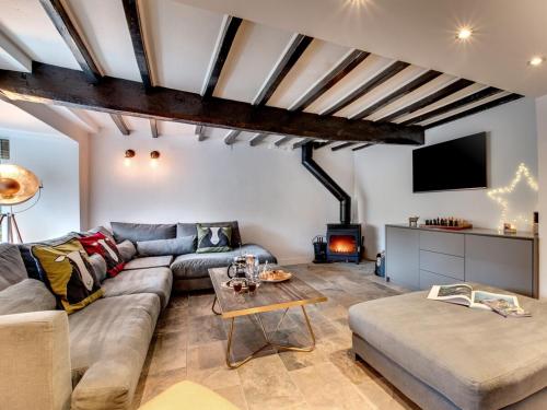 a living room with a couch and a table at The Nook by Luxury Travel Emporium Asygarth in Aysgarth