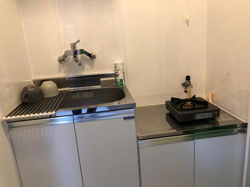 a small kitchen with a sink and a counter top at 桜屋Sakuraya201 in Tokyo